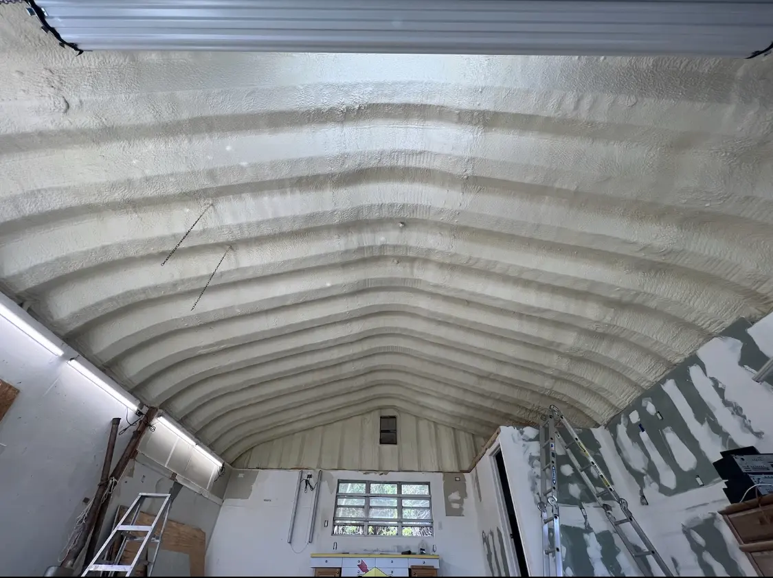 Spray polyurethane foam applied to the underside of a metal roof deck in Avon